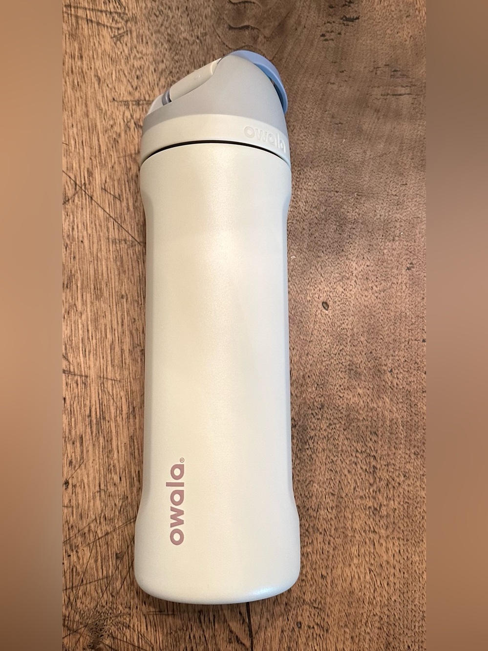 NWOT 24 oz. Owala Hearth and Hand Cream Water Bottle with Light Blue Accent.
